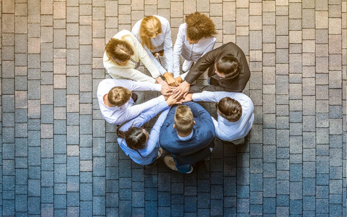 A group of people joined hands in the form of a circle