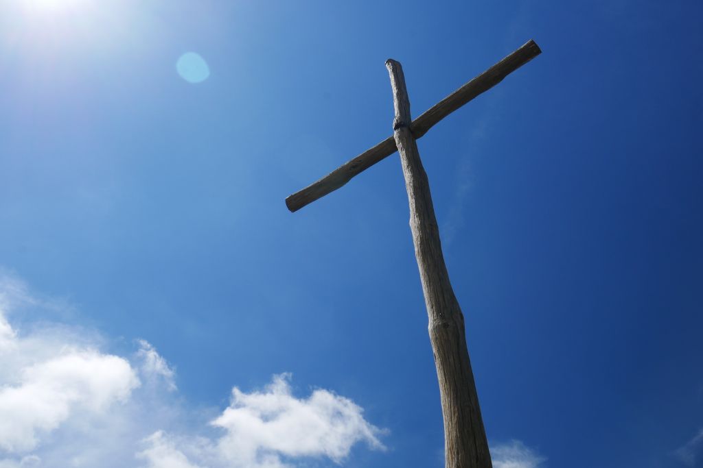 A close shot of a brown wooden cross