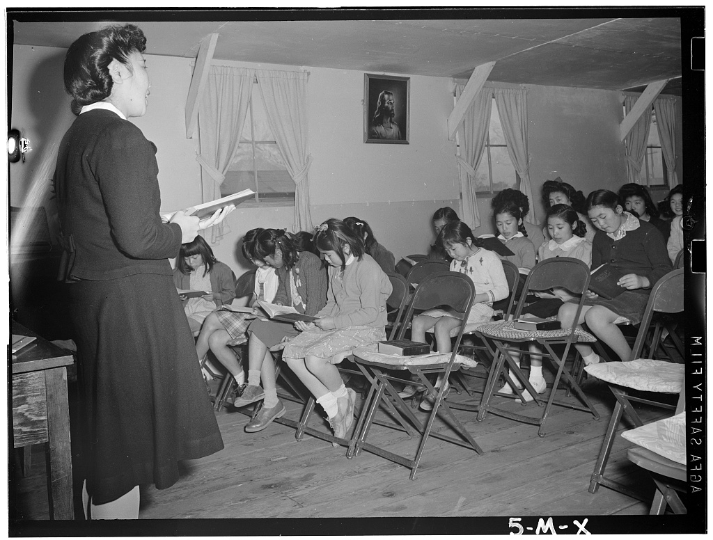 A black and white picture of teacher teaching kids in Sunday school