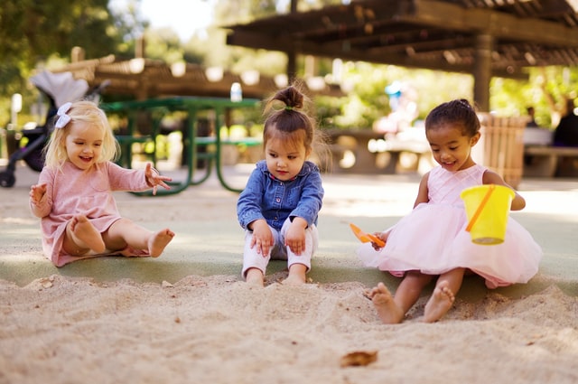 Three young girls playing in the park